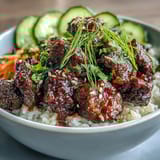 A vibrant bowl of Easy Korean Beef Bowl with savory ground beef, steamed cauliflower rice, and fresh, crunchy vegetables.