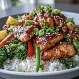 Steamed jasmine rice topped with savory chicken, crisp broccoli, carrots, bell pepper, and snap peas.