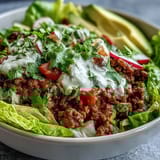 Vibrant Healthy Taco Bowl filled with seasoned ground beef, crisp romaine, diced tomatoes, and fresh cilantro.