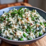 Creamy pea and mint risotto with Parmesan, vibrant spring flavors in a comforting Italian dish perfect for dinner parties.