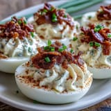 Creamy bacon ranch deviled eggs with smoky bacon crumbles and fresh herbs, a savory twist on a classic appetizer.