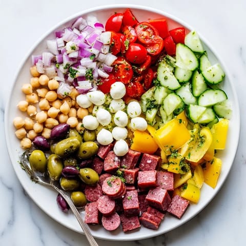 Vibrant Italian-American Crunchy Antipasto Chopped Salad served in a rustic white bowl.  