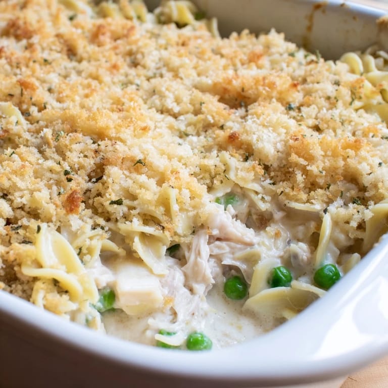 Bubbling, freshly baked Tuna Casserole fresh from the oven with melted cheddar cheese.