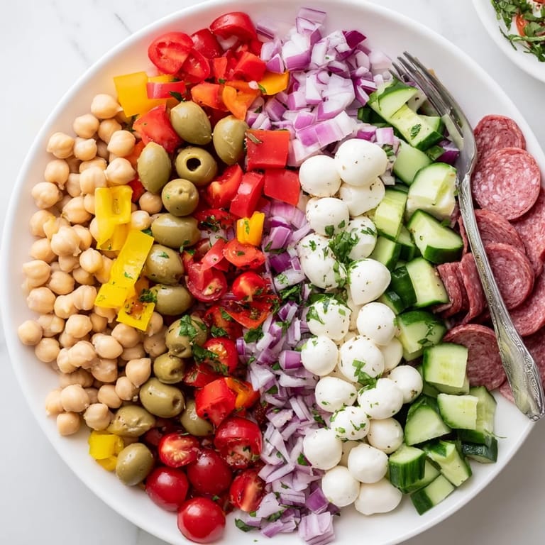 Tossed salad with crisp veggies, salami, and mozzarella, perfect for a quick lunch.