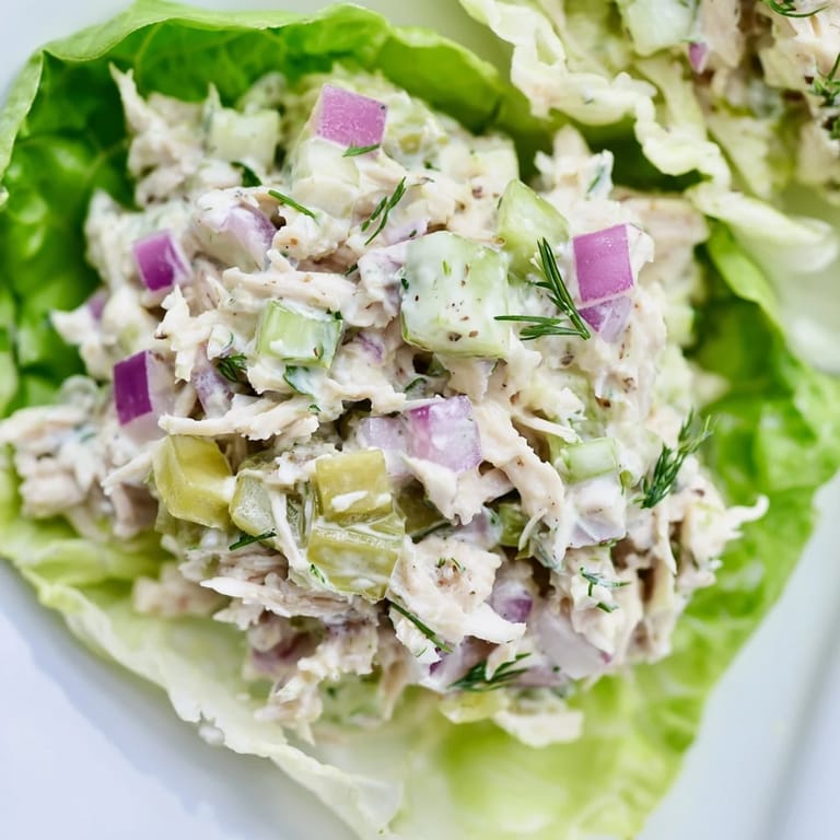 Serving Dill Pickle Chicken Salad Lettuce Cups on crisp green leaves, ready for a light, refreshing lunch.  