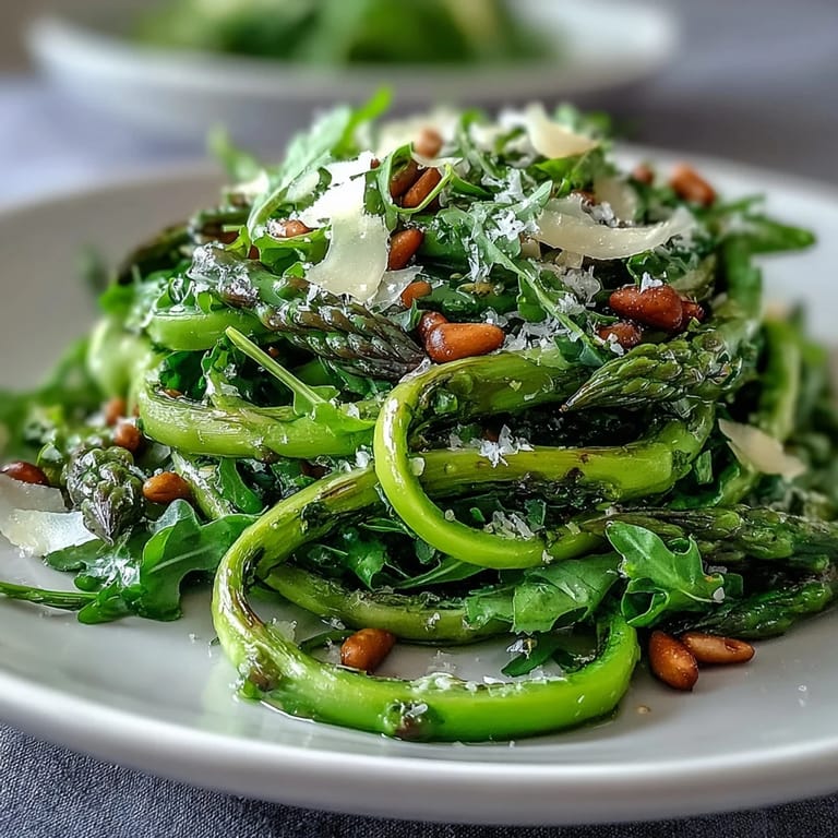 Vibrant shaved asparagus salad with zesty lemon dressing and nutty Parmesan cheese, perfect for a healthy appetizer.  