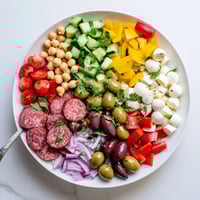 Colorful bowl of Crunchy Antipasto Chopped Salad with chickpeas, salami, and mozzarella.  