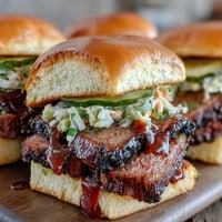Smoky, tender BBQ brisket sliders with tangy sauce and crisp slaw on soft buns, perfect for baby showers and parties.