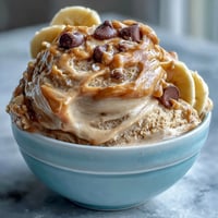 Creamy four-ingredient peanut butter banana ice cream with swirls of natural sweetness, perfect for a healthy, dairy-free dessert.  